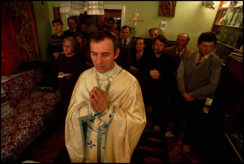 A priest leads a secret Catholic Mass a  private home in Ukraine, where the Roman Catholic Church has been banned since 1946, Lviv, Ukraine