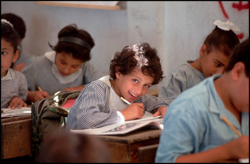 Several young children write in their books during class, Gaza Strip