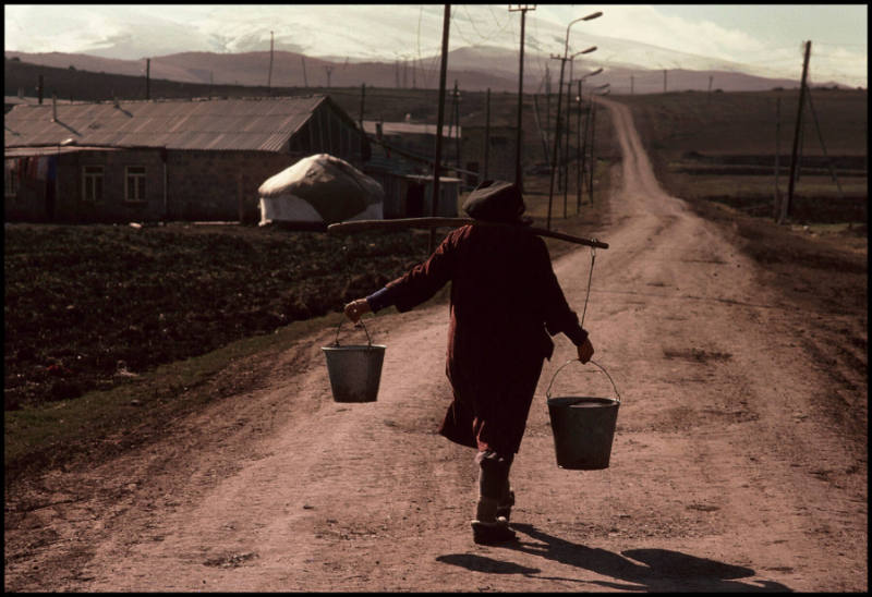 Armenian farmer carrying buckets, Armenia